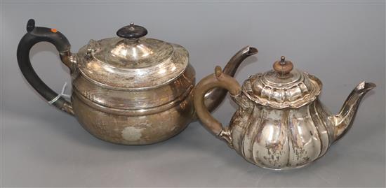 A George V Scottish silver teapot of plain oval form and an Edwardian bachelors teapot of fluted oval form gross 20.5 oz.